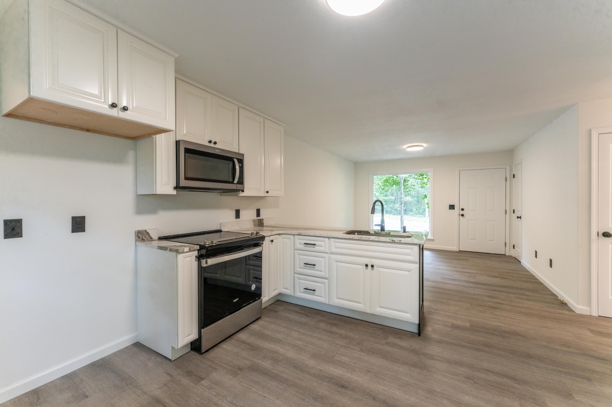 316 Kerrigan Road Crossville, TN 38555 - Photo 7 of 19 a kitchen with granite countertop white cabinets and stainless steel appliances