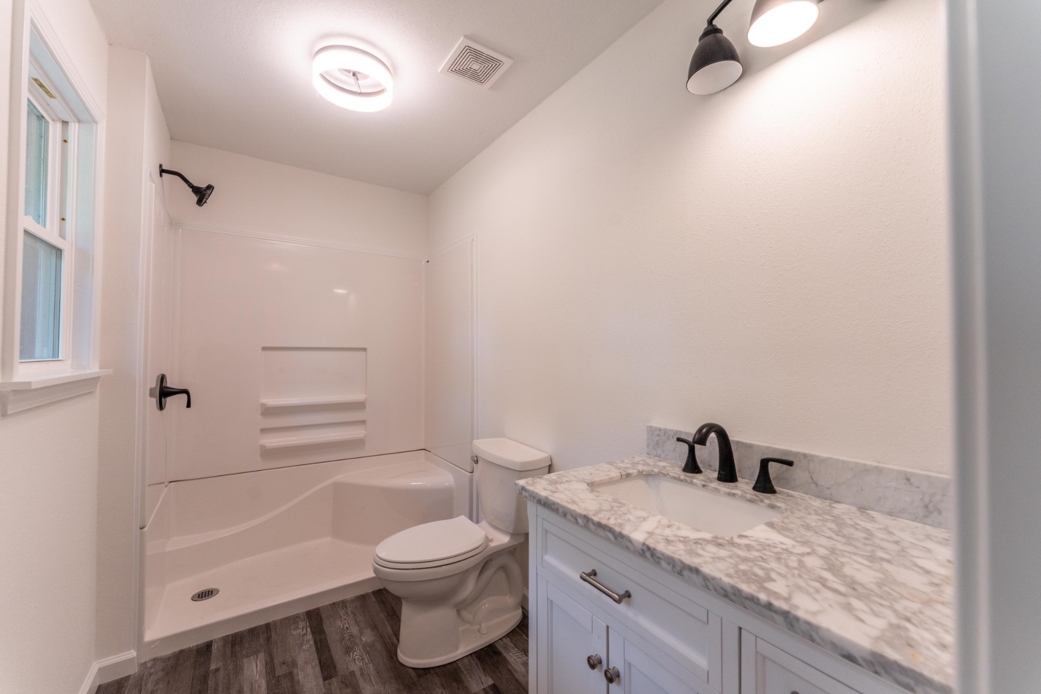 316 Kerrigan Road Crossville, TN 38555 - Photo 10 of 19 a bathroom with a granite countertop sink toilet a mirror and shower