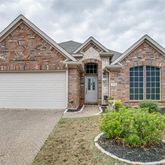 a view of a house with a yard and plants