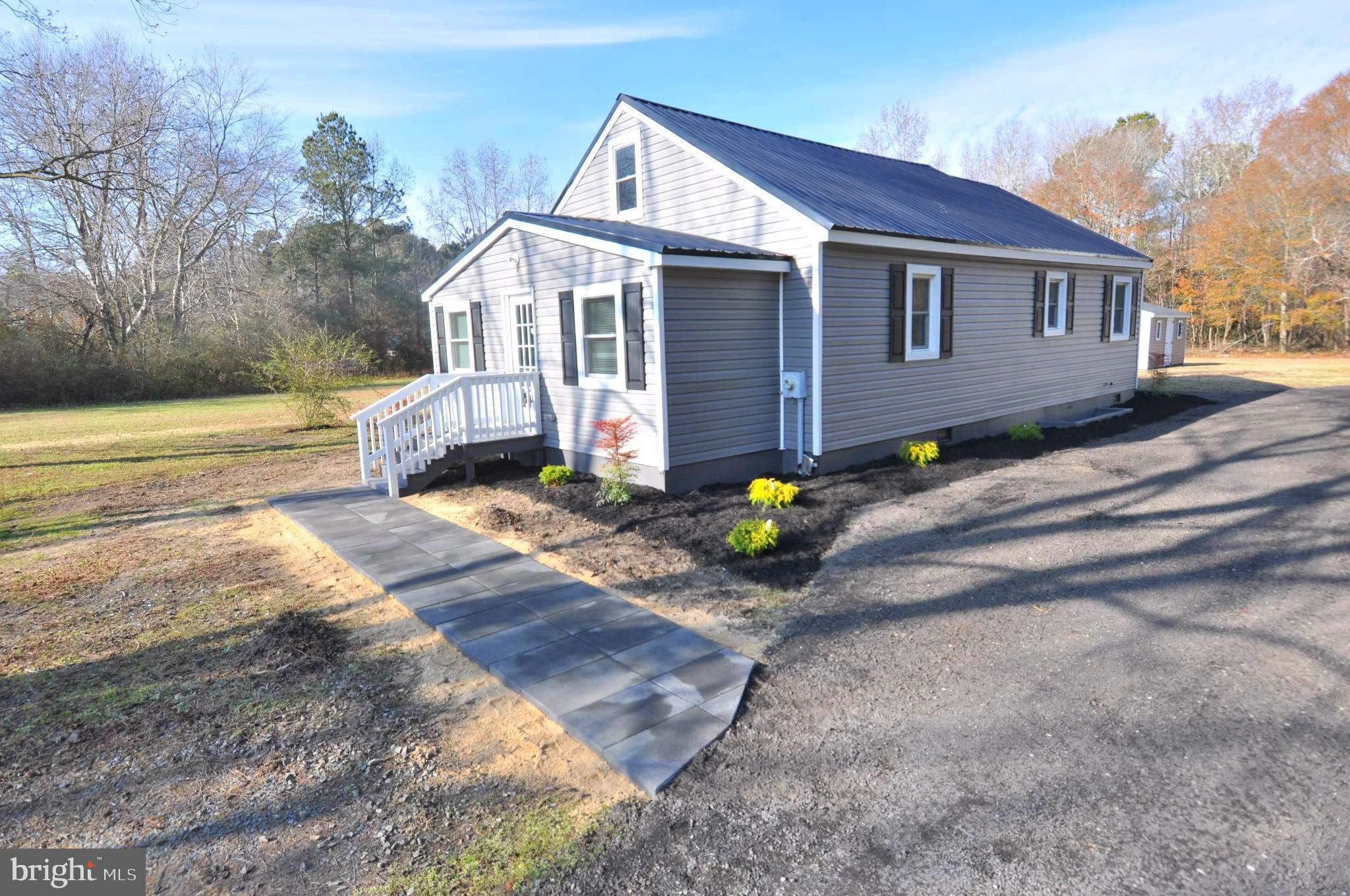1529 Unionville Road Pocomoke City, MD 21851 - Photo 1 of 33 a front view of a house with a garden