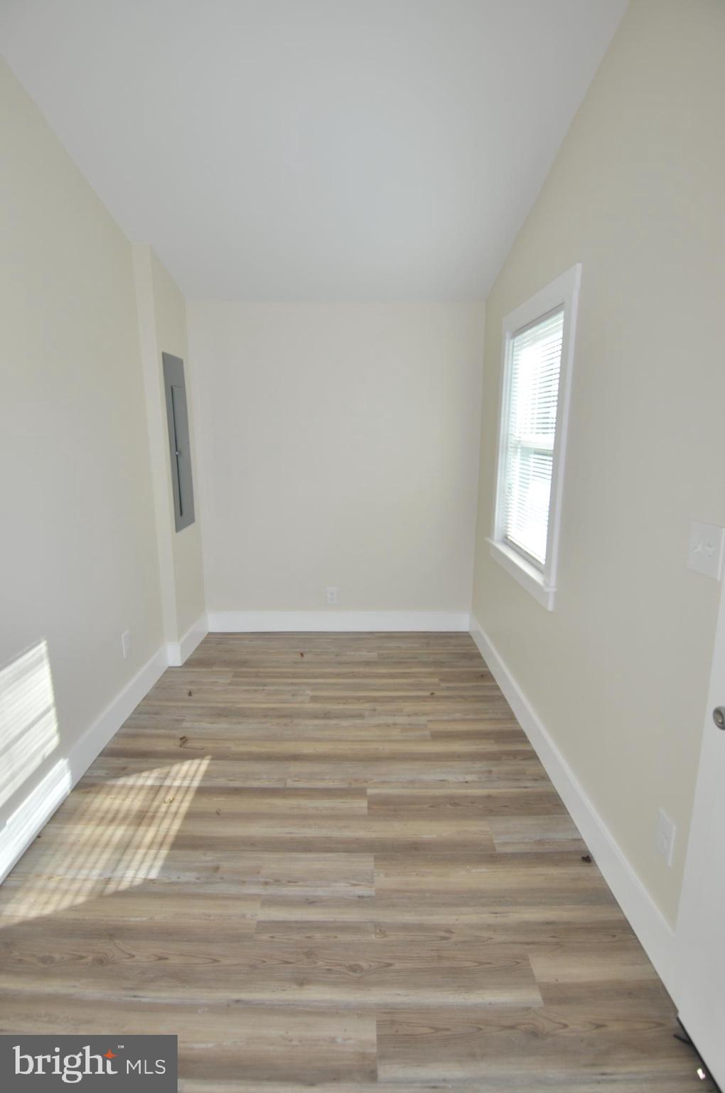 1529 Unionville Road Pocomoke City, MD 21851 - Photo 14 of 33 a view of an empty room with wooden floor and a window