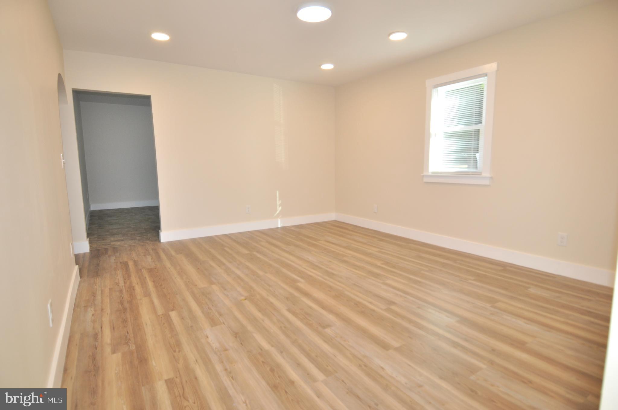 1529 Unionville Road Pocomoke City, MD 21851 - Photo 16 of 33 an empty room with wooden floor and windows