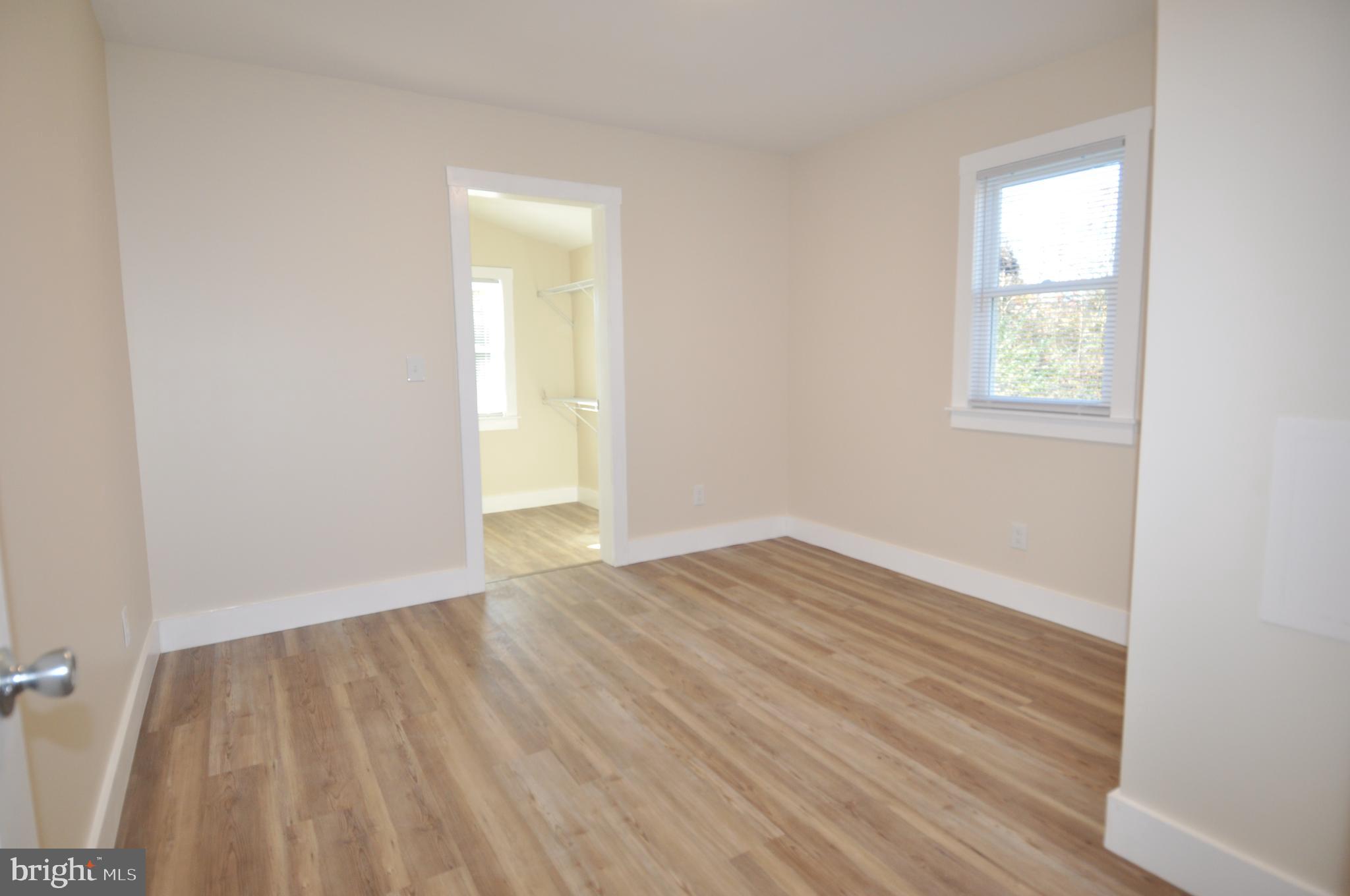 1529 Unionville Road Pocomoke City, MD 21851 - Photo 17 of 33 an empty room with wooden floor and windows
