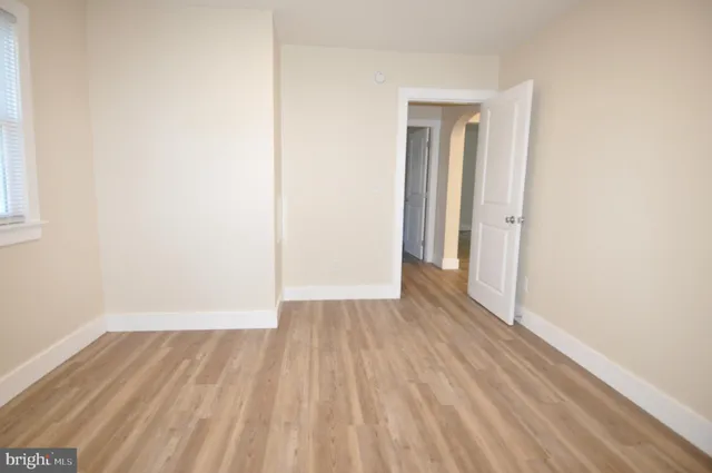 a view of a room with wooden floor and white doors