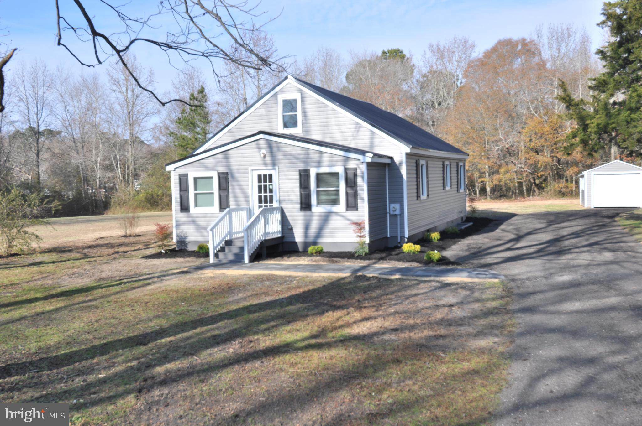 1529 Unionville Road Pocomoke City, MD 21851 - Photo 2 of 33 a front view of a house with a garden and pathway