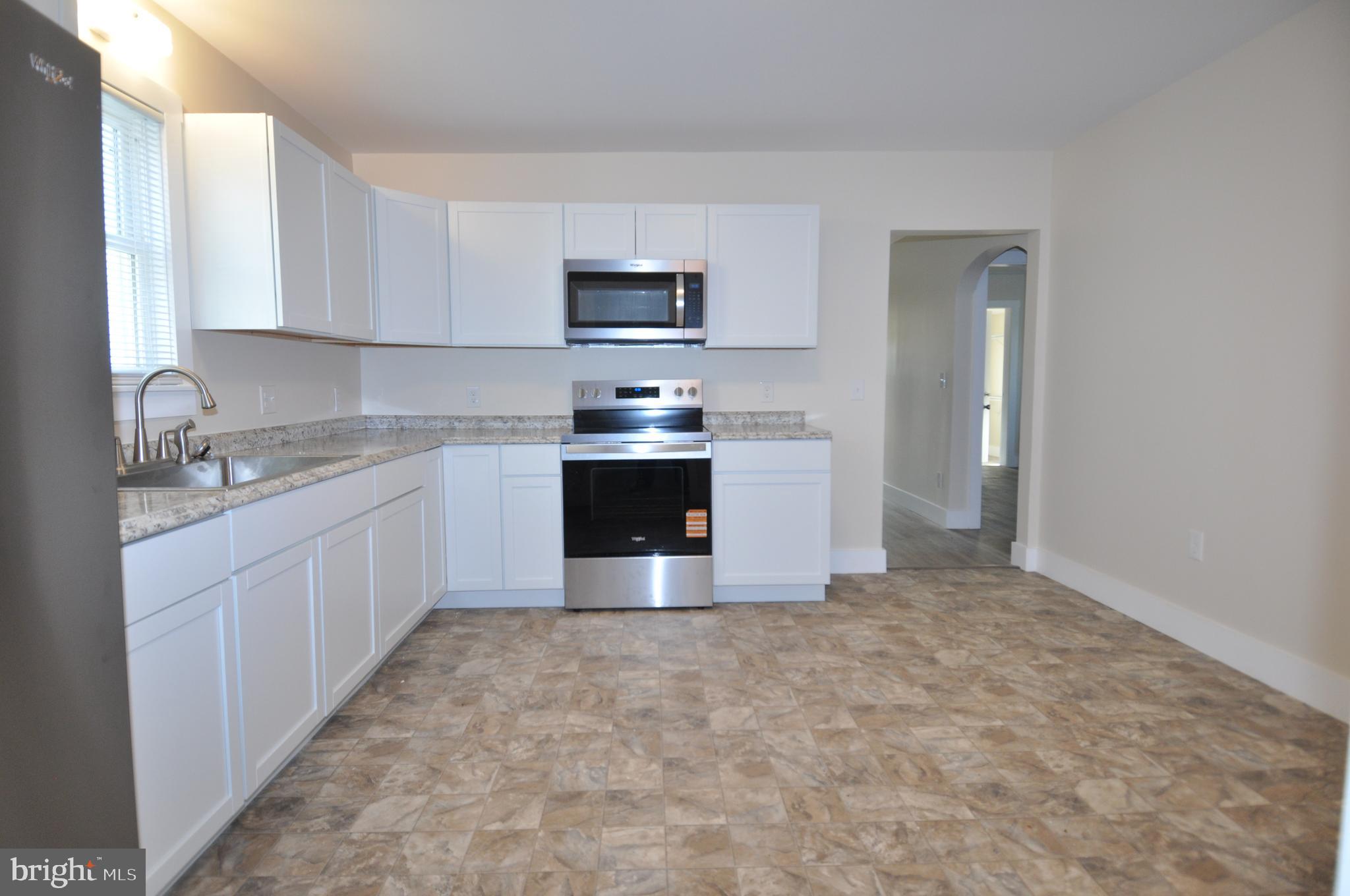 1529 Unionville Road Pocomoke City, MD 21851 - Photo 28 of 33 a kitchen with stainless steel appliances a sink and a stove