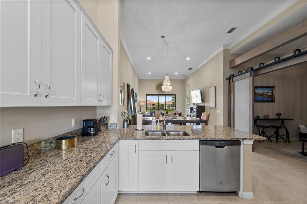 9366 Pocida Court, Unit 202 Naples, FL 34119 - Photo 11 of 44 a kitchen with sink cabinets and window