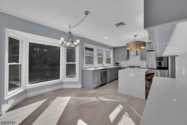 a view of a livingroom with a staircase and white walls