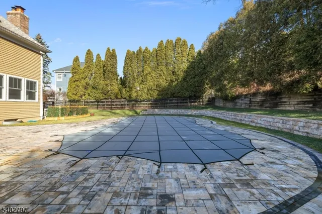 a view of a swimming pool with an outdoor seating and a garden
