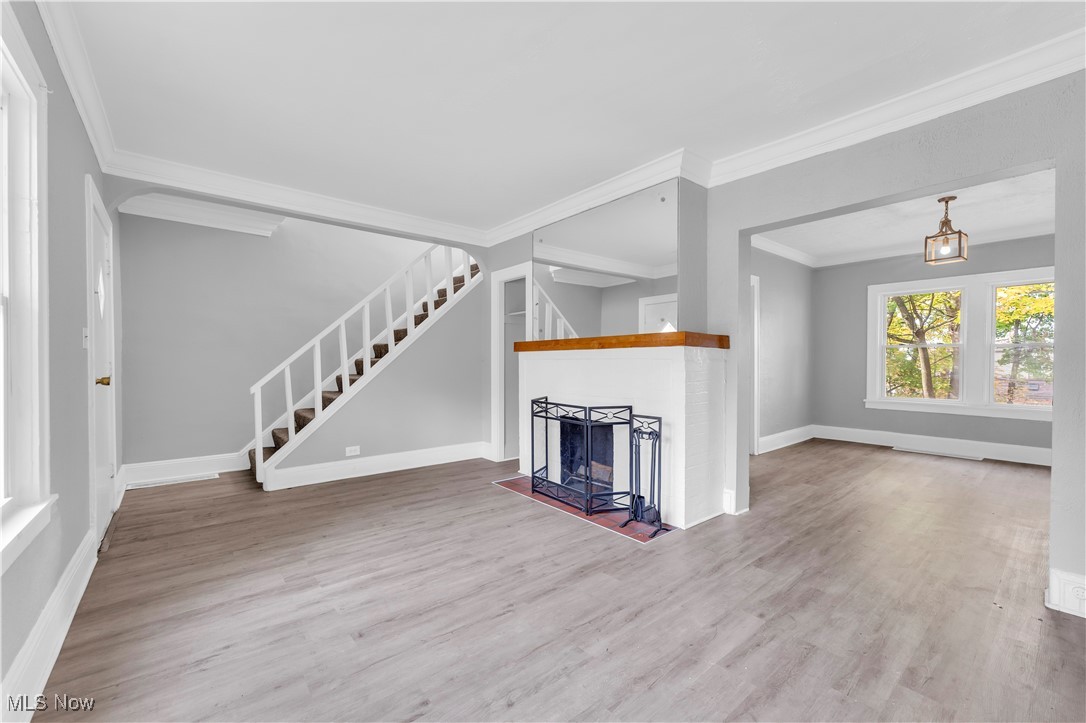 3245 Oak Road Cleveland, OH 44118 - Photo 5 of 24 Unfurnished living room featuring crown molding and wood-type flooring