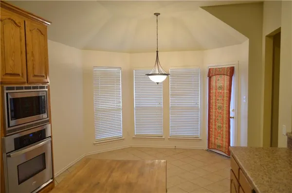 a view of a livingroom with a fireplace and chandelier fan