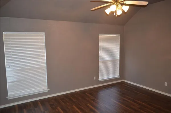 a view of a small space with wooden floor and a window
