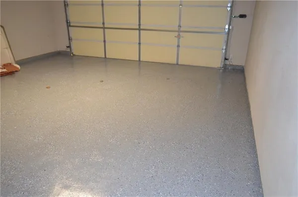 a backyard of house with wooden fence and large trees