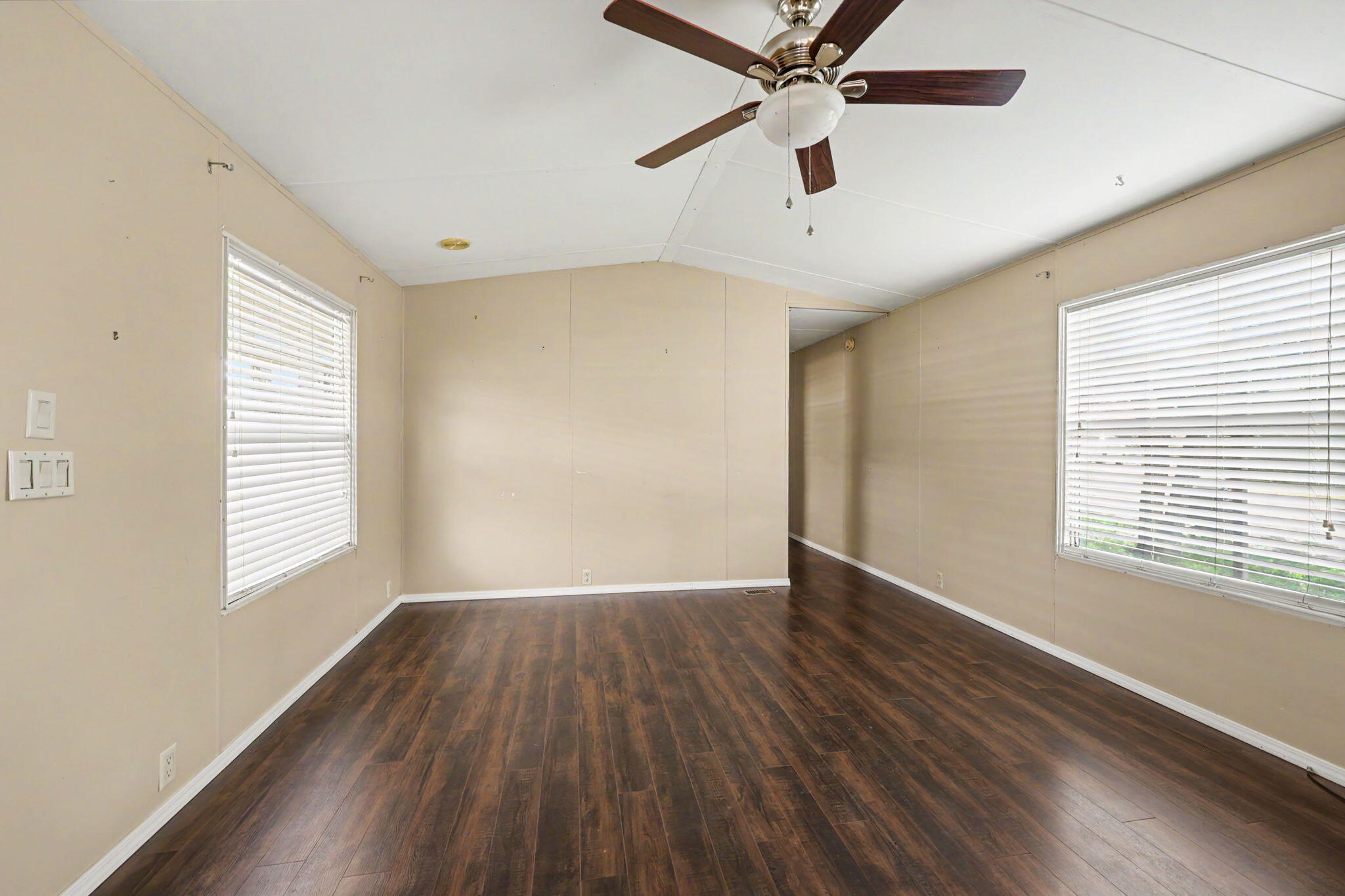 421 Stevens Road, Unit 34 Eagle Point, OR 97524 - Photo 11 of 19 a view of an empty room with wooden floor and a window
