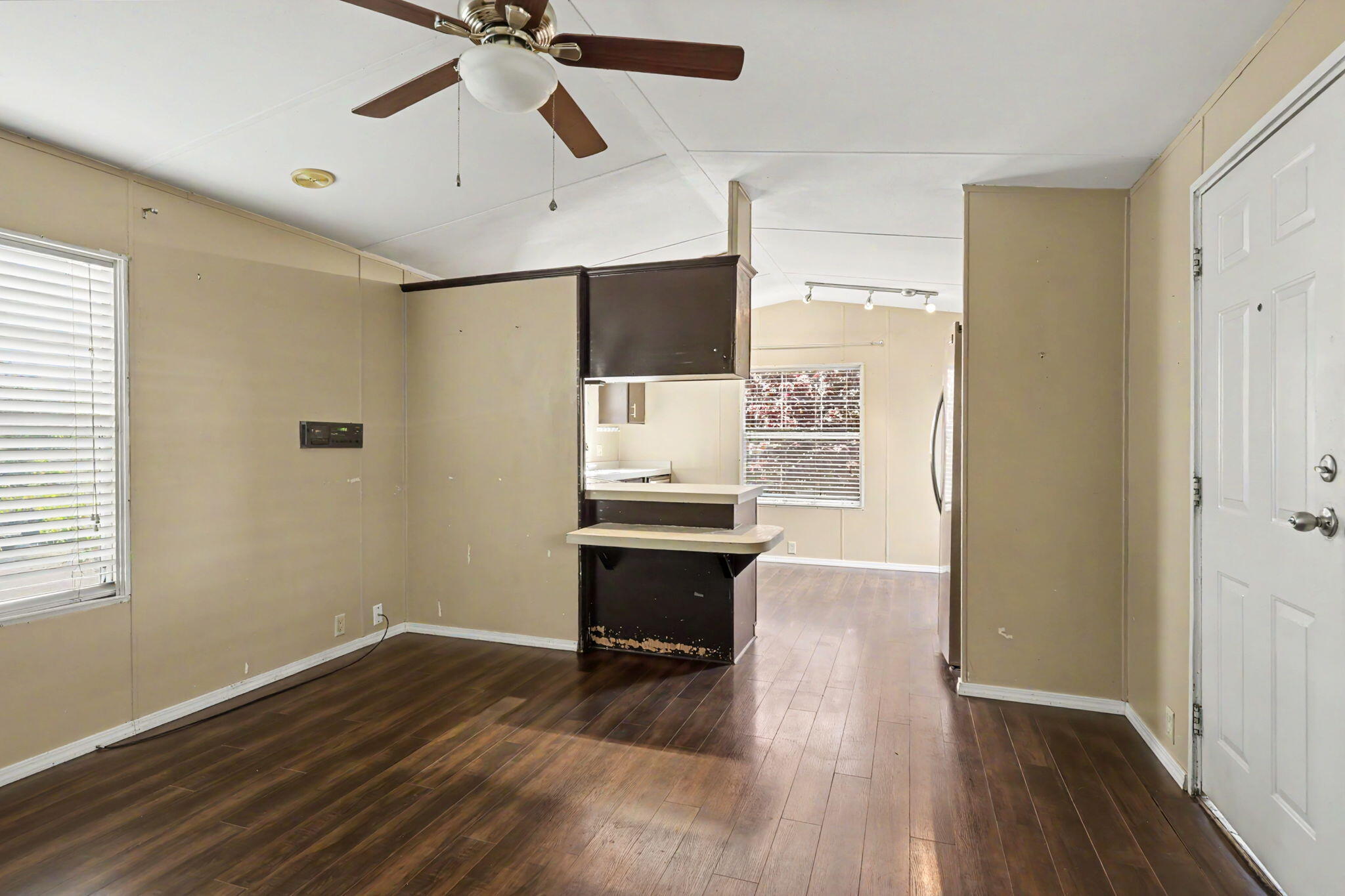 421 Stevens Road, Unit 34 Eagle Point, OR 97524 - Photo 7 of 19 a view of a room with wooden floor a ceiling fan and windows