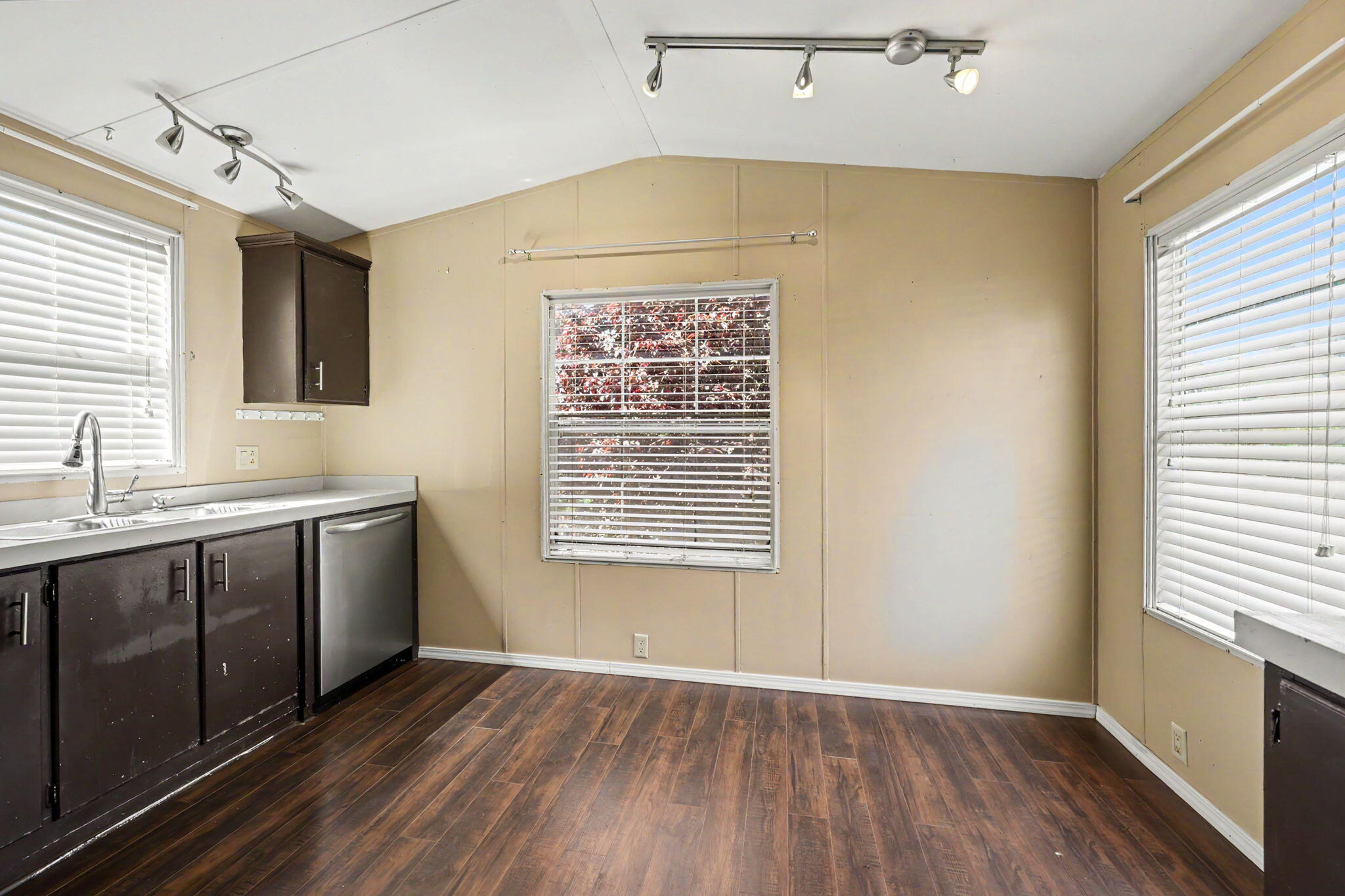 421 Stevens Road, Unit 34 Eagle Point, OR 97524 - Photo 8 of 19 a view of an empty room with a window and wooden floor