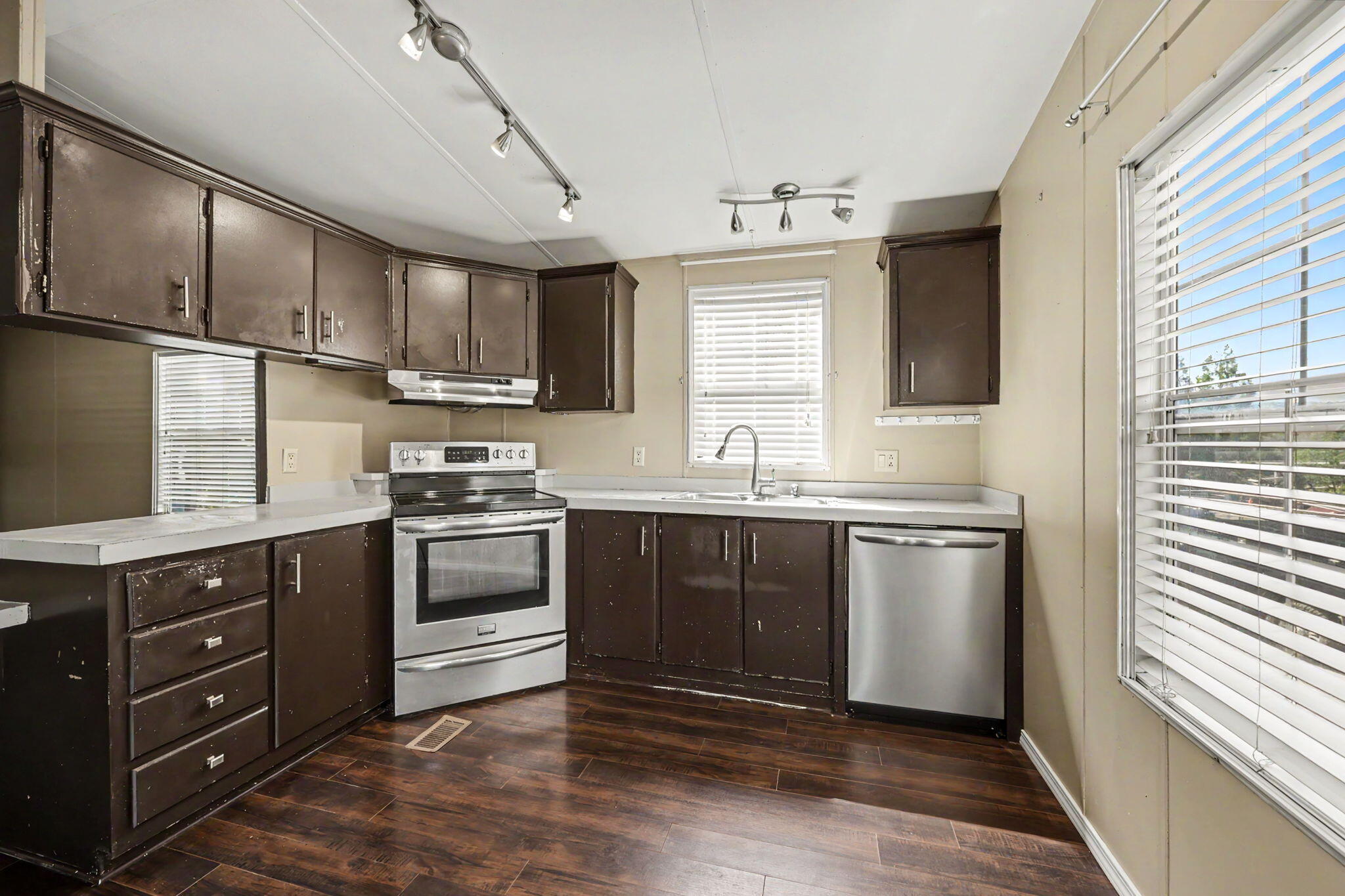 421 Stevens Road, Unit 34 Eagle Point, OR 97524 - Photo 9 of 19 a kitchen with granite countertop a sink cabinets and stainless steel appliances
