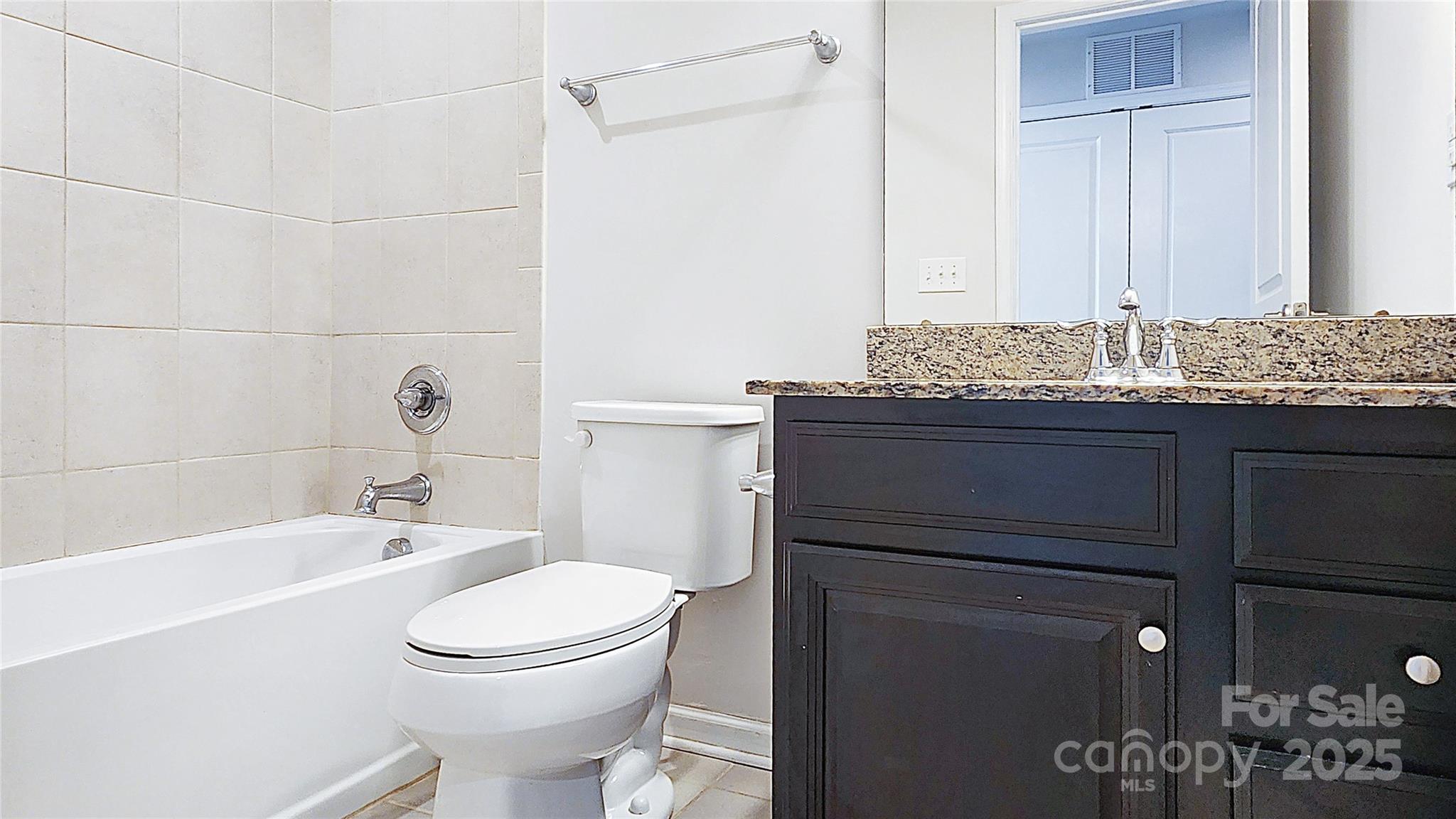 11044 Telegraph Road Northwest Concord, NC 28027 - Photo 23 of 25 a bathroom with a granite countertop sink toilet and shower