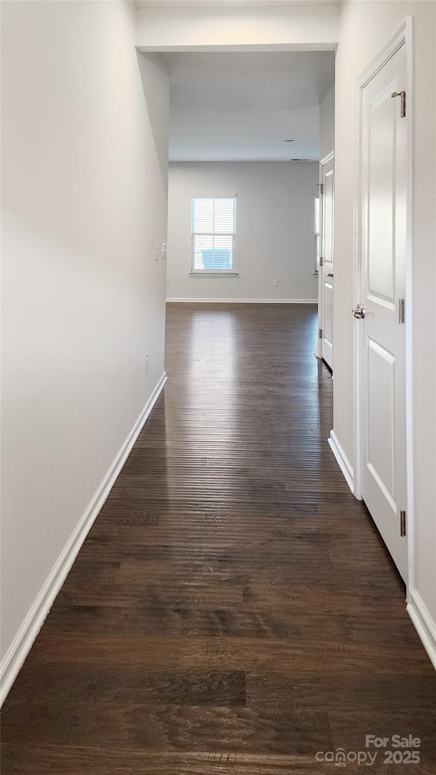 11044 Telegraph Road Northwest Concord, NC 28027 - Photo 4 of 25 a view of an empty room with wooden floor and a window