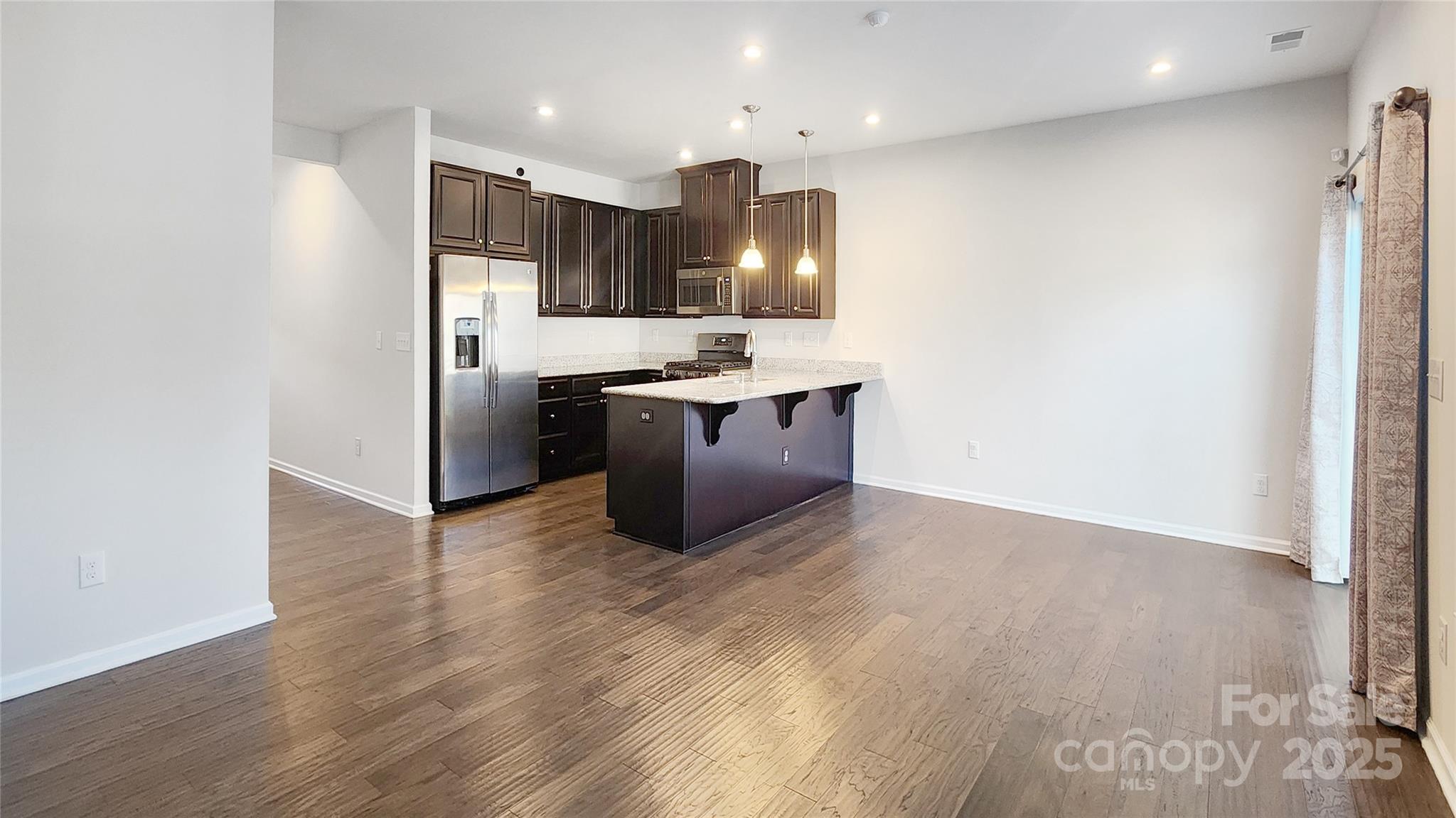 11044 Telegraph Road Northwest Concord, NC 28027 - Photo 5 of 25 a kitchen with stainless steel appliances granite countertop a refrigerator a sink and a stove