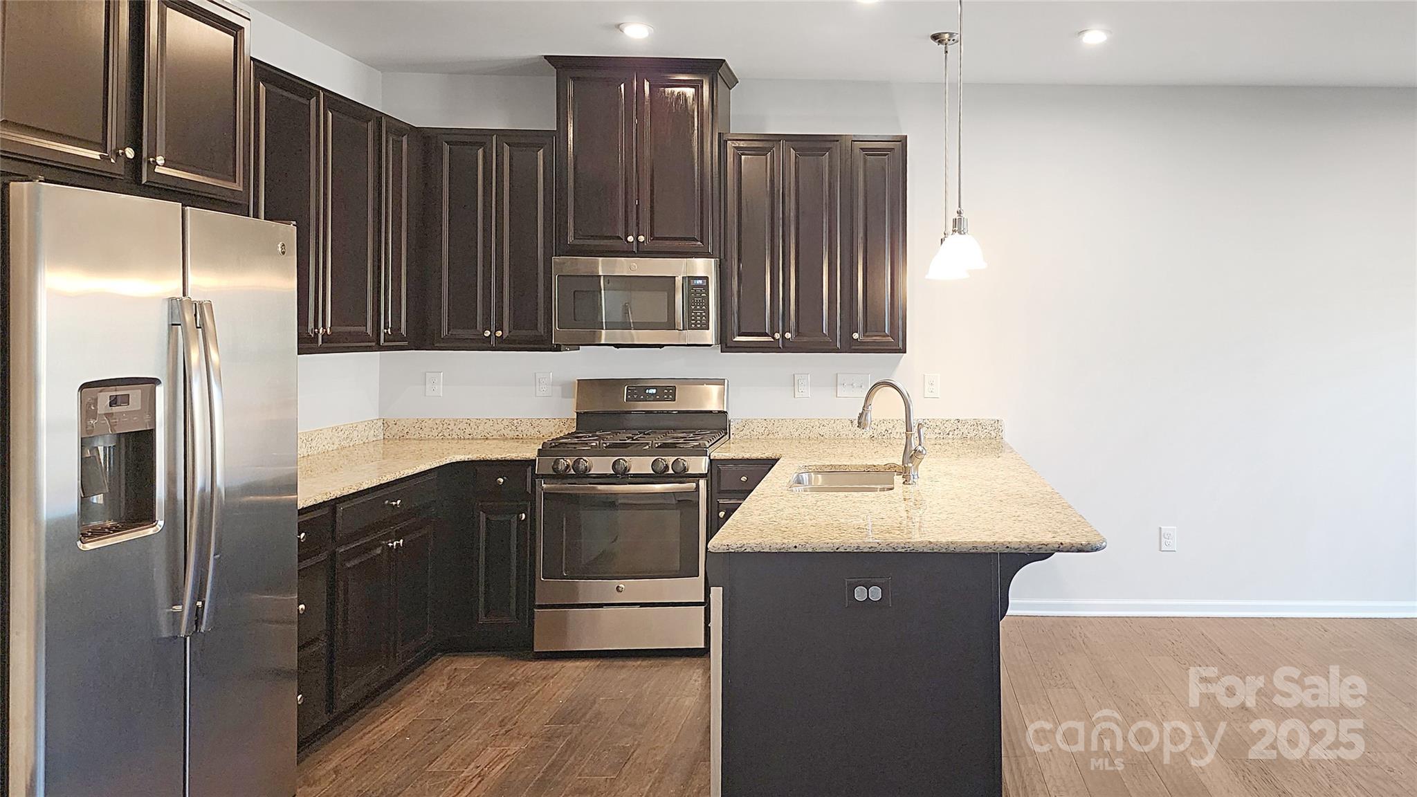 11044 Telegraph Road Northwest Concord, NC 28027 - Photo 8 of 25 a kitchen with stainless steel appliances granite countertop a sink stove and refrigerator