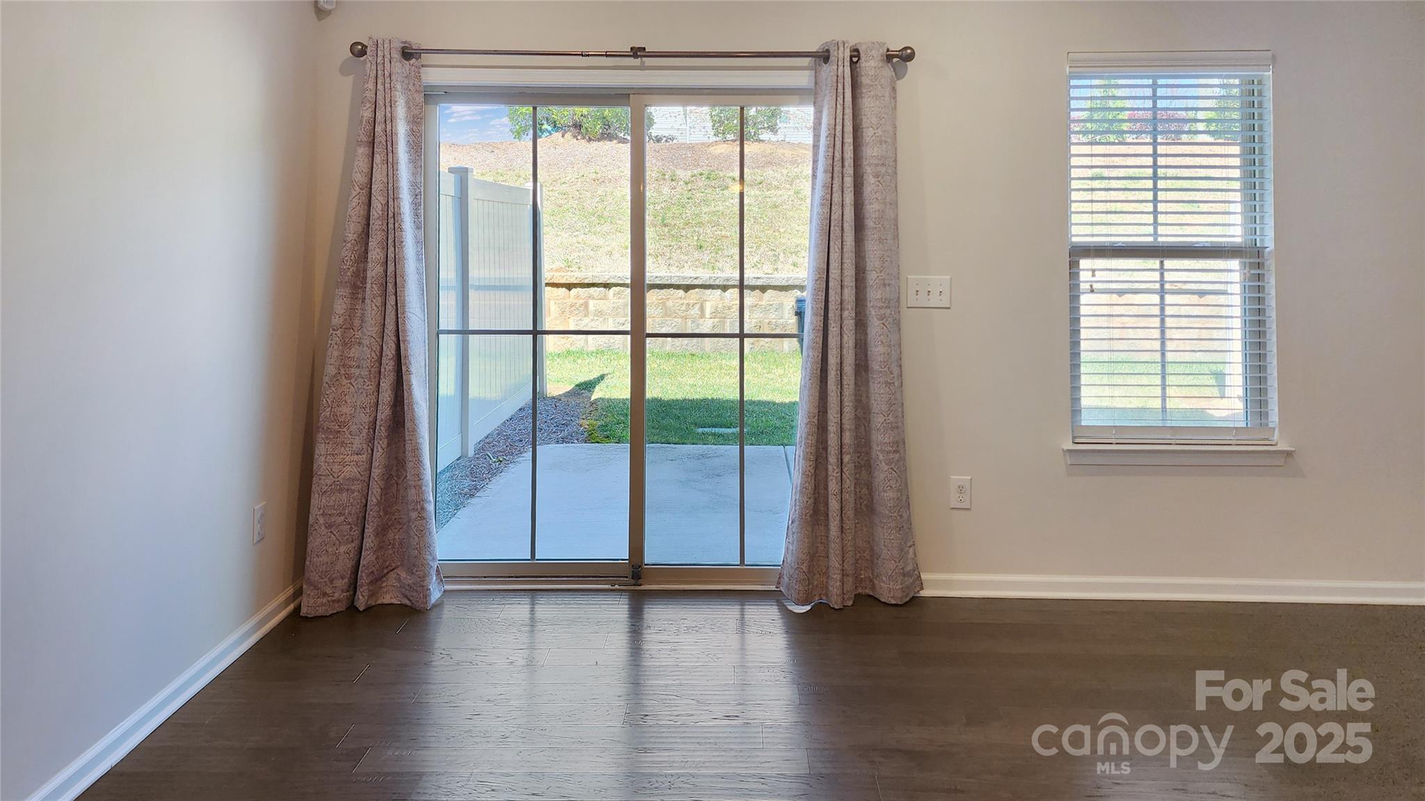 11044 Telegraph Road Northwest Concord, NC 28027 - Photo 10 of 25 an empty room with wooden floor and windows