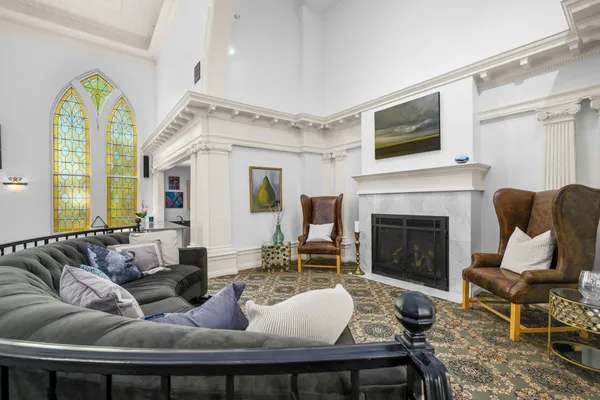 a living room with lots of furniture and white walls