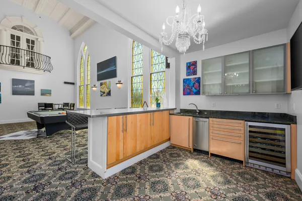 a view or kitchen with stainless steel appliances granite countertop a sink a stove and a refrigerator