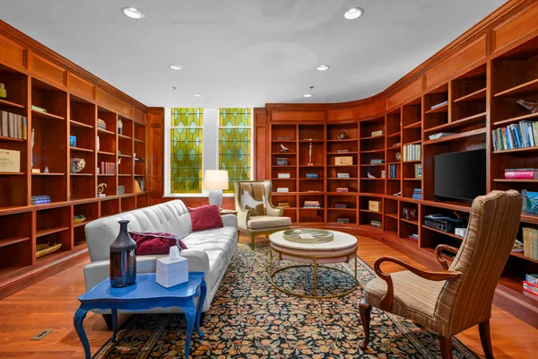 a bedroom with a bed couch and a window