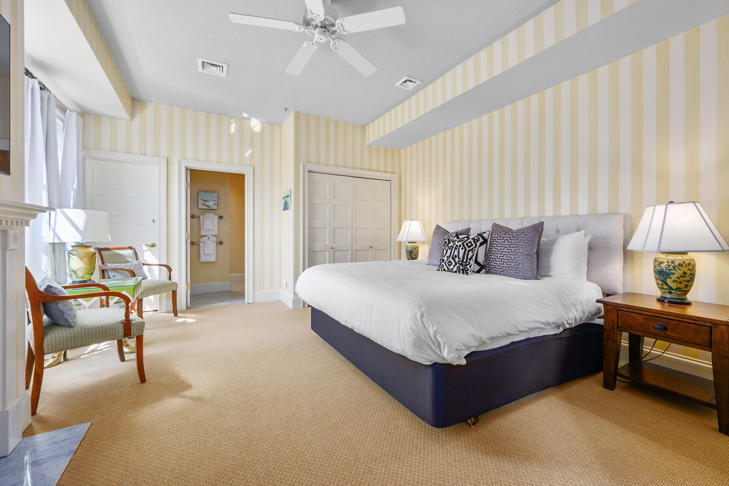 143 Main Street Sandwich, MA 02563 - Photo 33 of 39 a spacious bedroom with a bed a table and chair