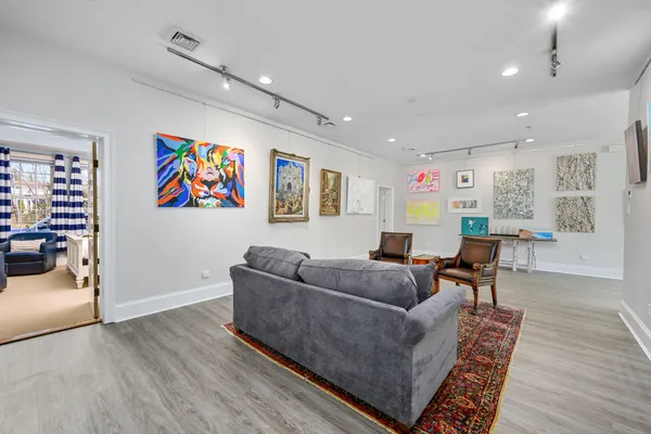 a spacious bedroom with a bed a flat screen tv and a fireplace