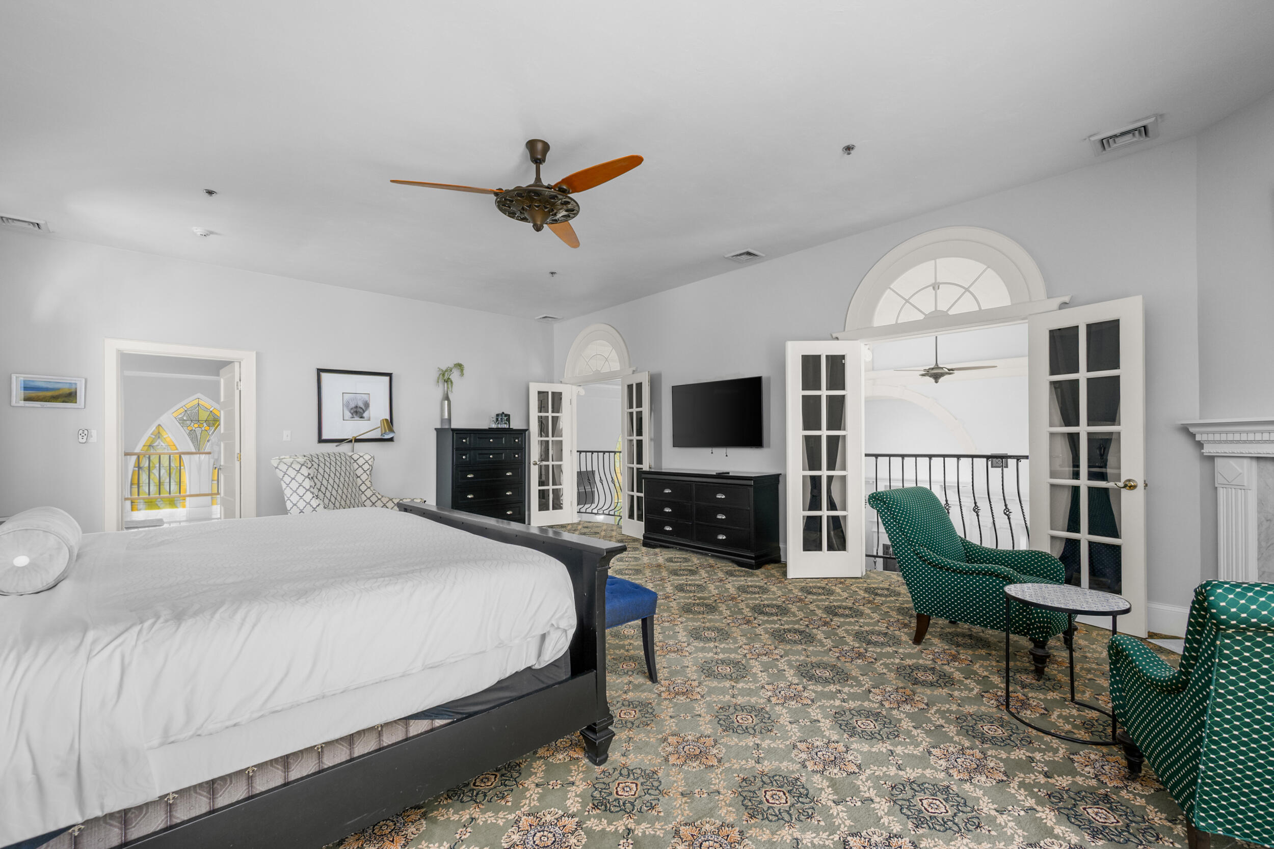 143 Main Street Sandwich, MA 02563 - Photo 38 of 39 a spacious bedroom with a bed a flat screen tv and a fireplace