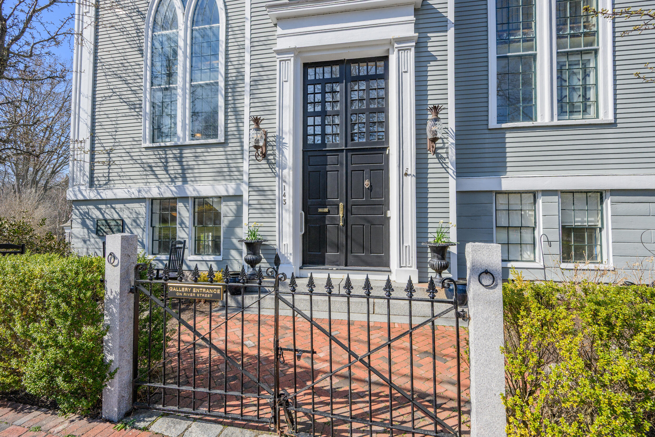143 Main Street Sandwich, MA 02563 - Photo 7 of 39 front view of a house with a large window and potted plants