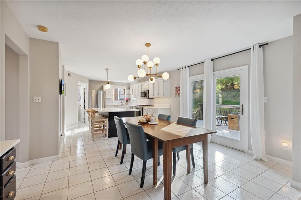 3018 White Pine Drive Gibsonia, PA 15044 - Photo 12 of 38 a view of a dining room with furniture and a chandelier