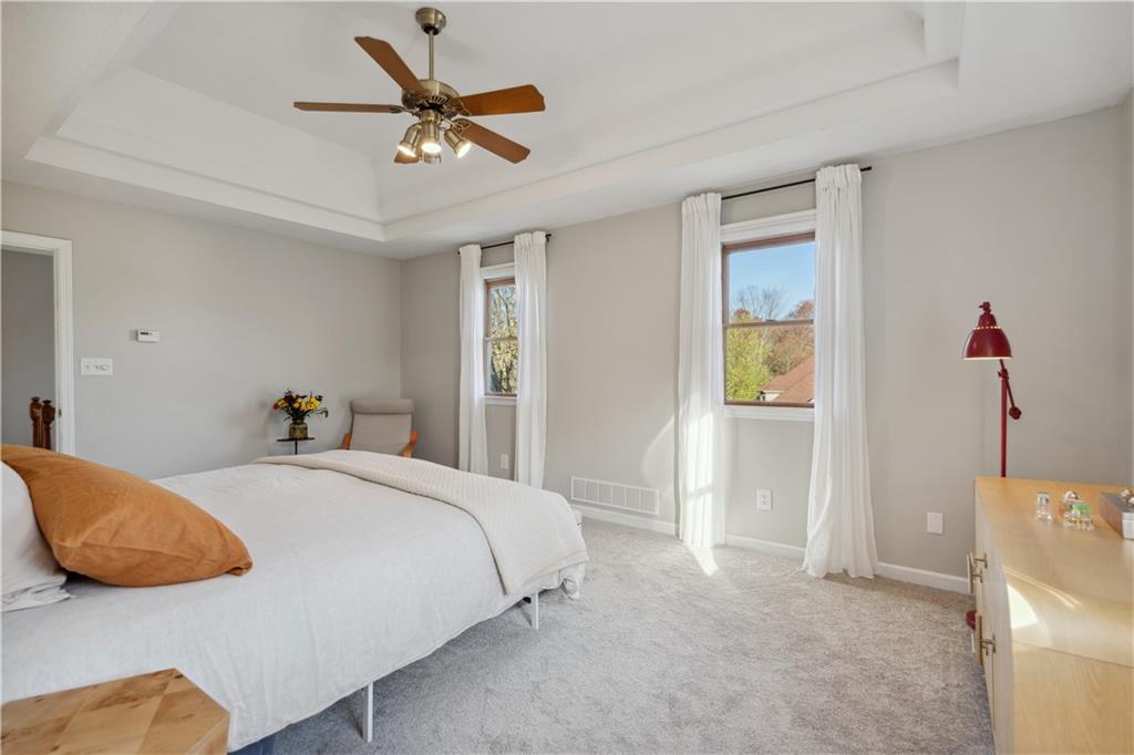 3018 White Pine Drive Gibsonia, PA 15044 - Photo 17 of 38 a bedroom with a bed and a chandelier