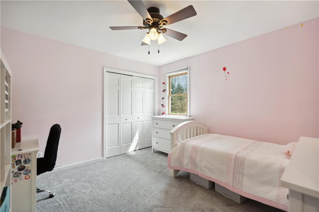 3018 White Pine Drive Gibsonia, PA 15044 - Photo 26 of 38 a bedroom with a bed and a chandelier