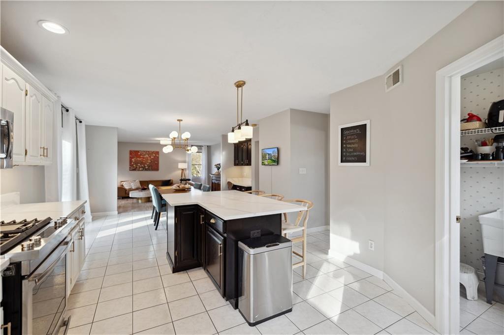 3018 White Pine Drive Gibsonia, PA 15044 - Photo 9 of 38 a kitchen with kitchen island a sink counter top space and appliances