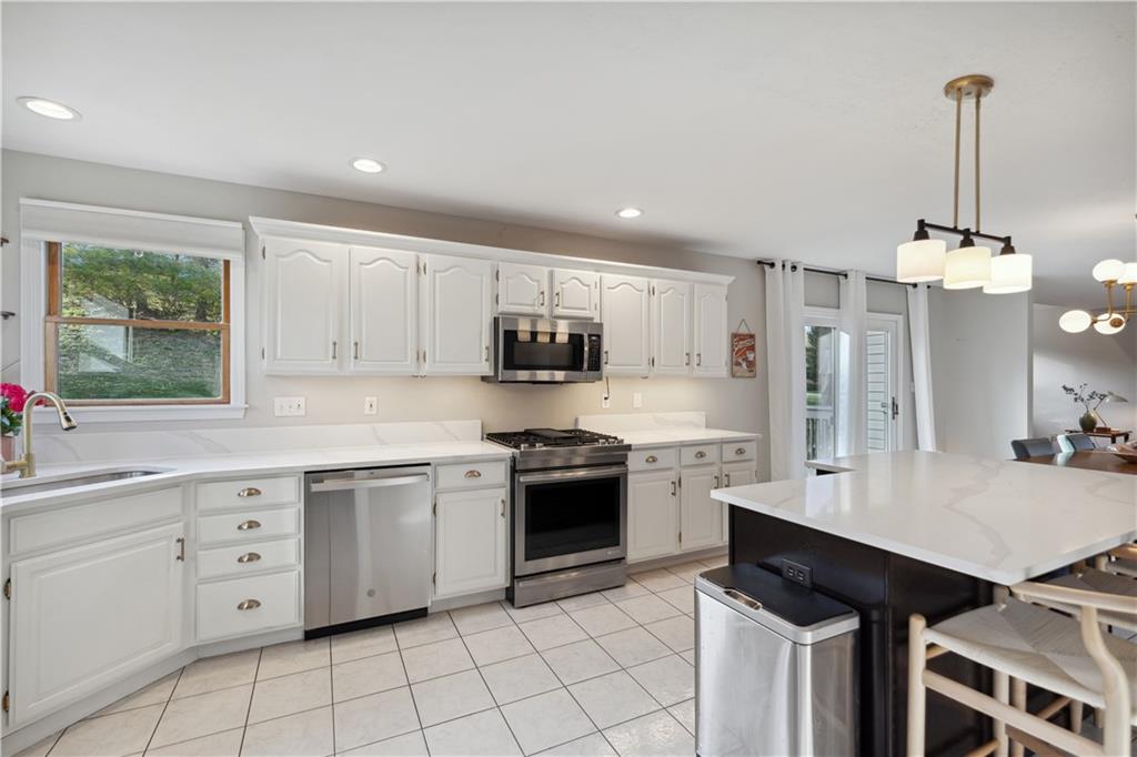 3018 White Pine Drive Gibsonia, PA 15044 - Photo 10 of 38 a kitchen with granite countertop white cabinets white stainless steel appliances with a sink and dishwasher