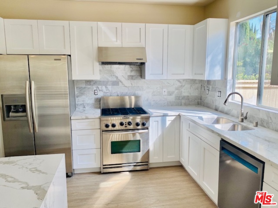 16 Nebraska Irvine, CA 92606 - Photo 13 of 18 a kitchen with stainless steel appliances a stove a sink and a refrigerator