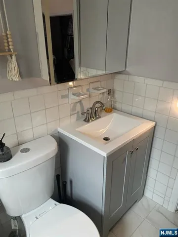 a bathroom with a sink toilet and mirror