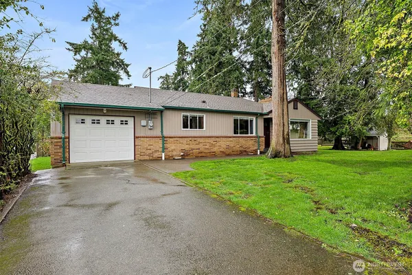 a front view of house with yard and green space