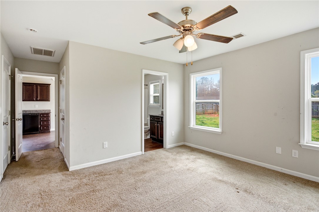 245 Maple Grove Road Seneca, SC 29678 - Photo 20 of 40 This spacious bedroom offers comfortable carpeting and abundant natural light.