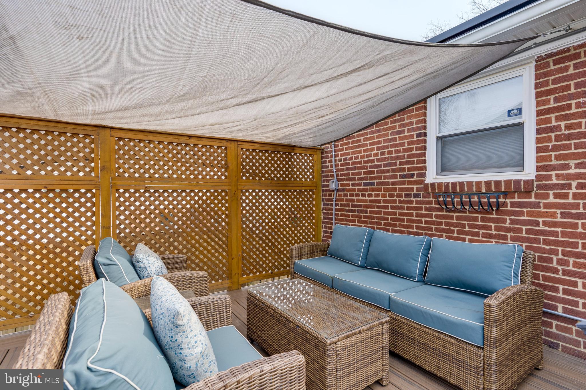 3707 Everton Street Silver Spring, MD 20906 - Photo 24 of 52 a view of a patio with couches and a dining table with wooden floor