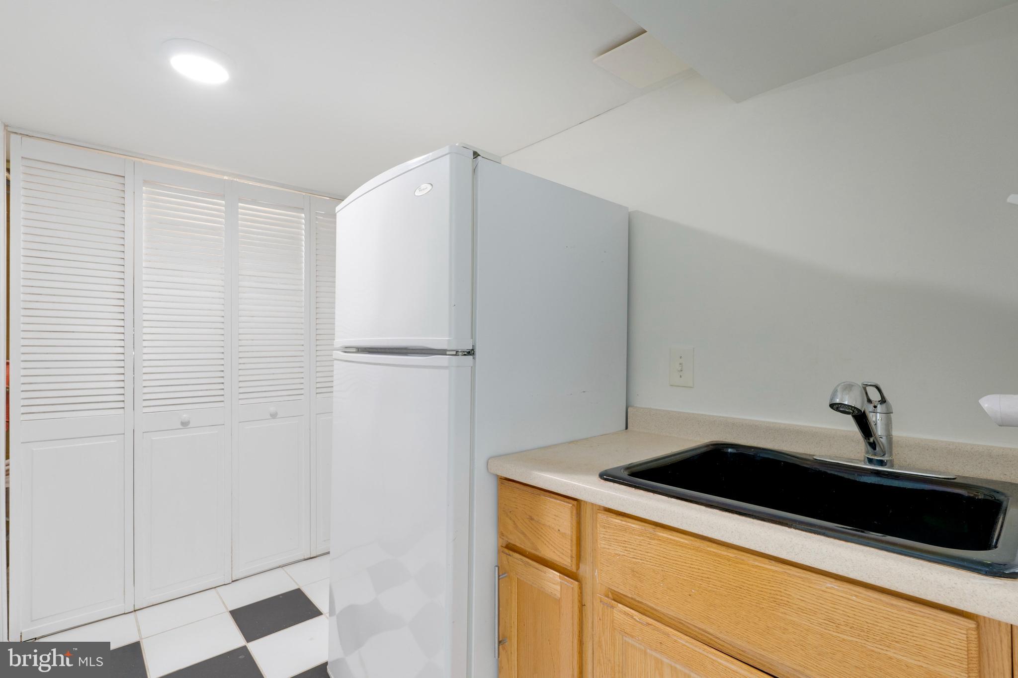 3707 Everton Street Silver Spring, MD 20906 - Photo 44 of 52 a kitchen with a sink and a refrigerator