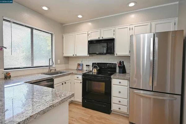 a kitchen with a refrigerator stove and sink