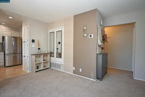 a view of a kitchen with refrigerator and microwave