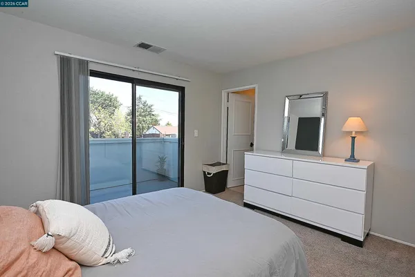 a bedroom with a bed and a large window