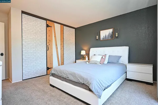 a bedroom with a bed lamp and a window