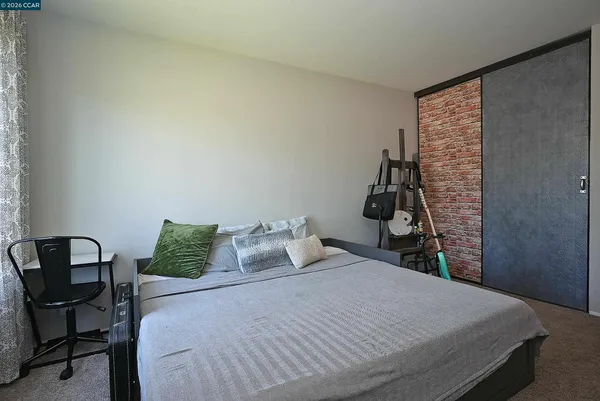 a bedroom with a bed and chair