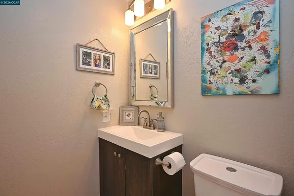 a bathroom with a sink mirror and toilet